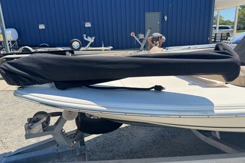 Slide: The Image of 2015 Scout 177 Sport boat on trailer, covered and parked outdoors. - 16