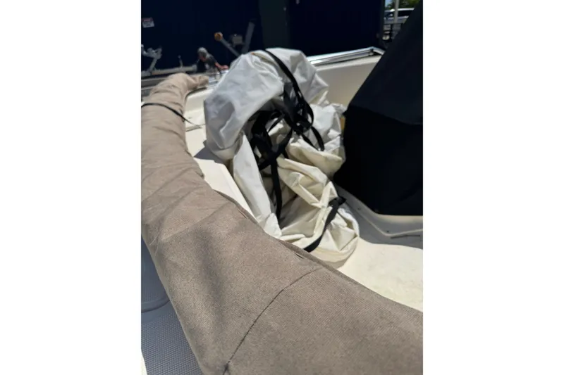 Slide: The Image of 2015 Scout 177 Sport boat interior with covered equipment and gear. - 19