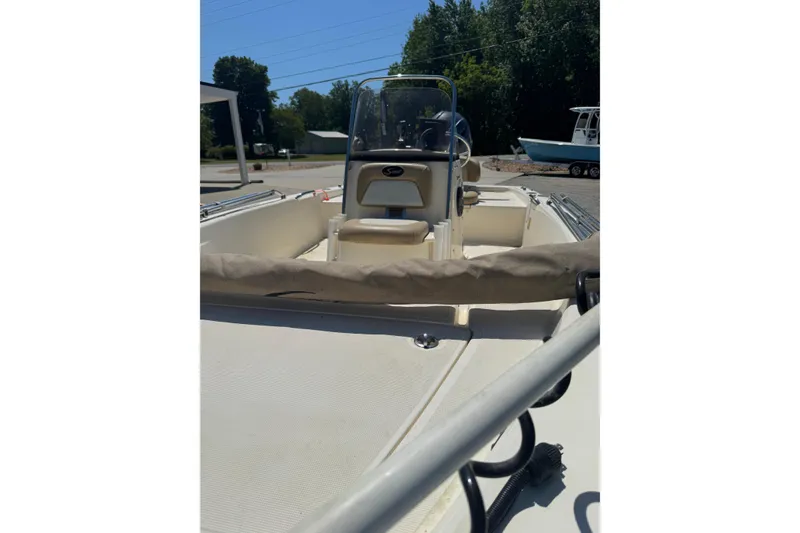 Slide: The Image of 2015 Scout 177 Sport boat interior with console and seating, outdoors. - 4