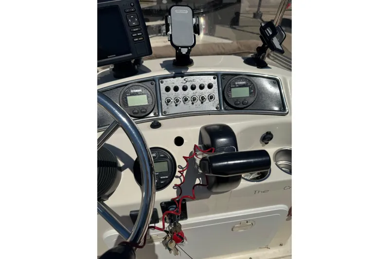 Slide: The Image of Control panel of a 2015 Scout 177 Sport boat with steering wheel and gauges. - 6