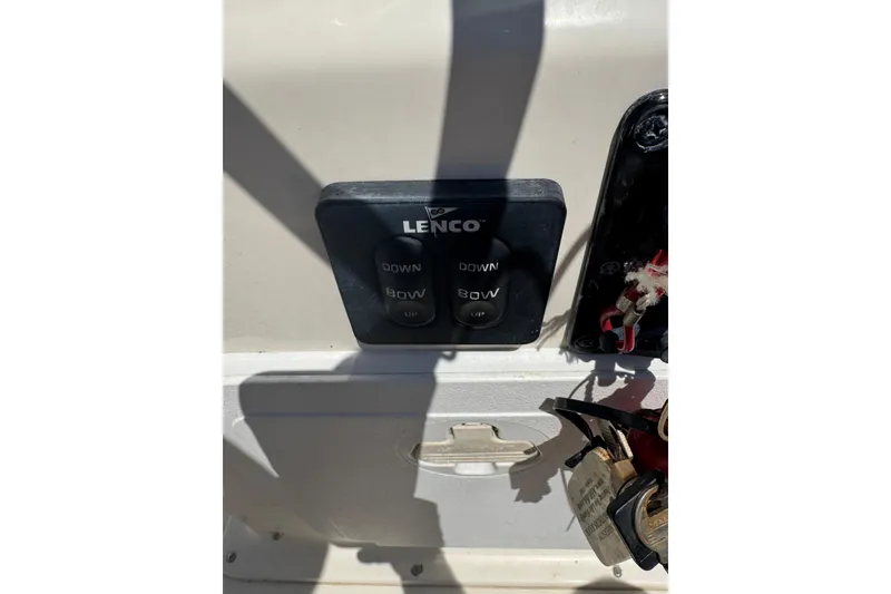 Slide: The Image of Control panel of a 2015 Scout 177 Sport boat with Lenco trim tab switches. - 7