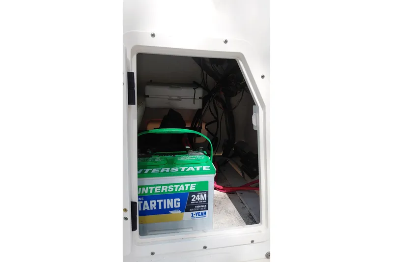 Slide: The Image of Battery compartment of a 2005 Boston Whaler 170 Montauk boat, featuring an Interstate battery. - 11