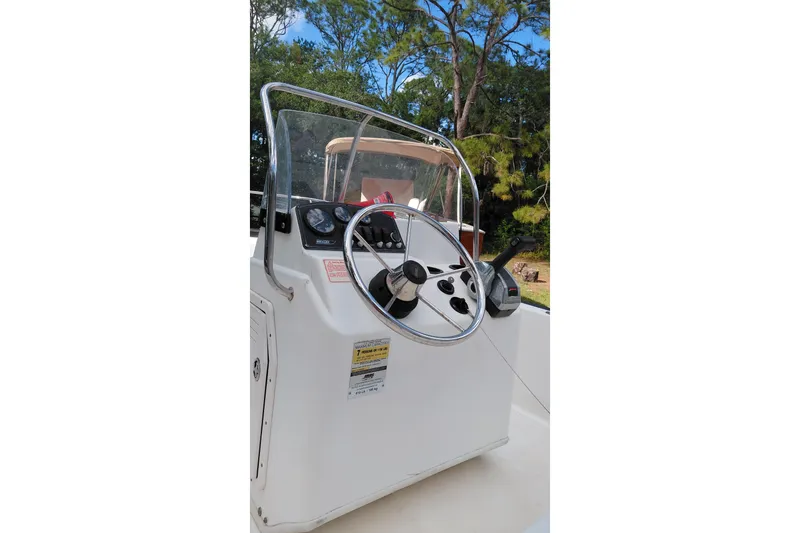 Slide: The Image of 2005 Boston Whaler 170 Montauk boat console with steering wheel and controls. - 12