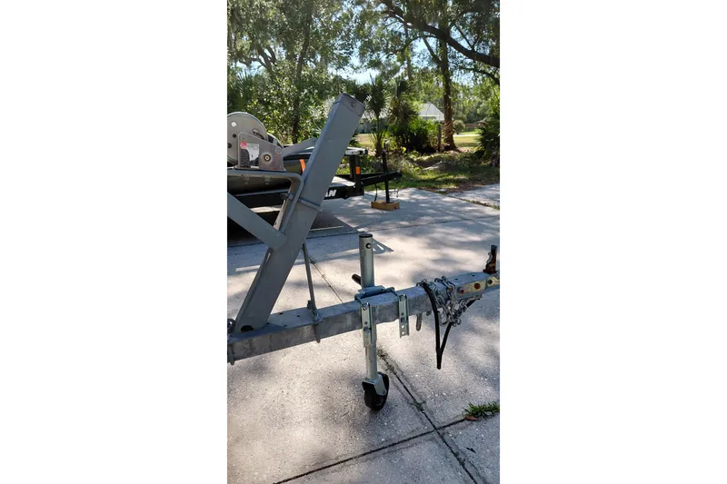 Slide: The Image of Trailer for 2005 Boston Whaler 170 Montauk parked on a sunny driveway. - 19
