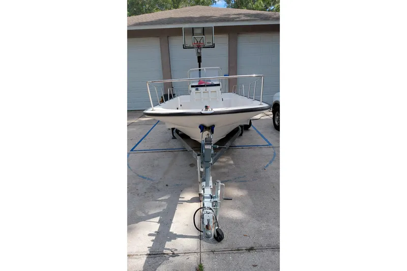 Slide: The Image of 2005 Boston Whaler 170 Montauk boat on trailer in driveway. - 4