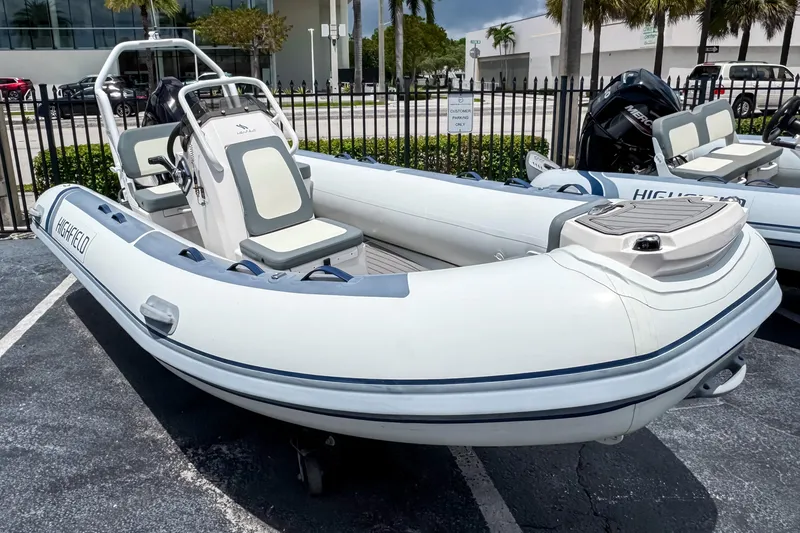 Slide: The Image of 2023 Highfield Classic 420 inflatable boat parked outdoors. - 2