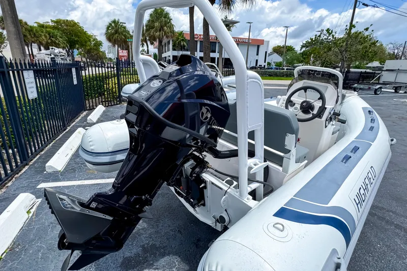 Slide: The Image of 2023 Highfield Classic 420 inflatable boat with outboard motor in a parking lot. - 3