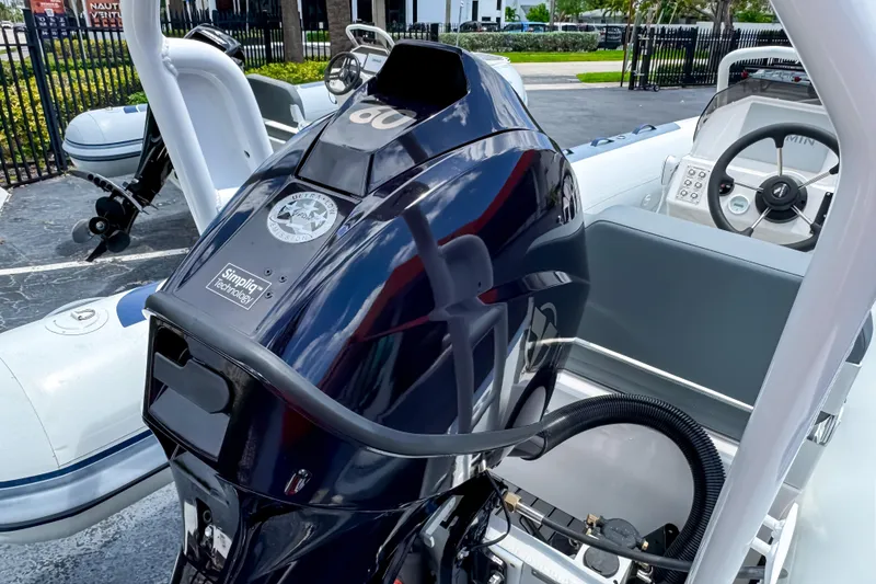 Slide: The Image of 2023 Highfield Classic 420 boat with powerful outboard motor, sleek design, and modern controls. - 4