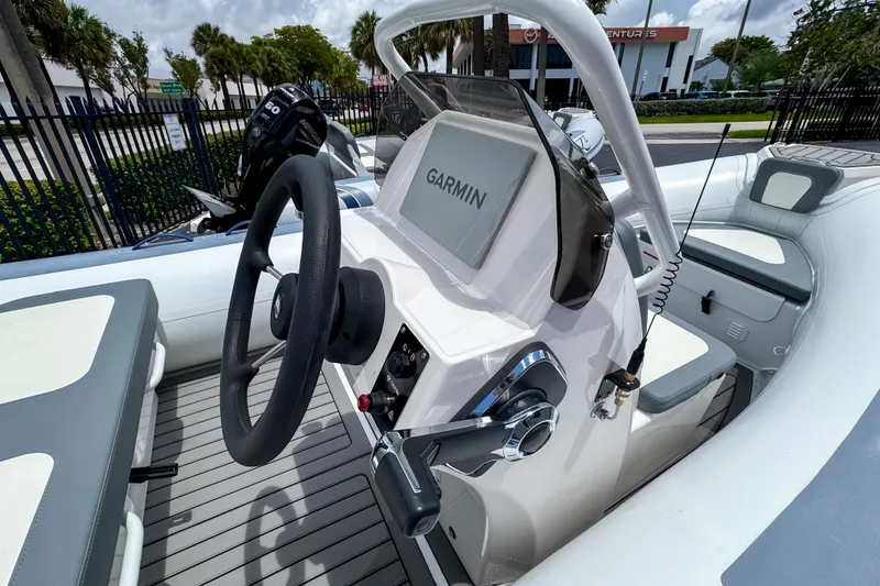 Slide: The Image of 2023 Highfield Classic 420 boat interior with Garmin navigation system and steering wheel. - 8