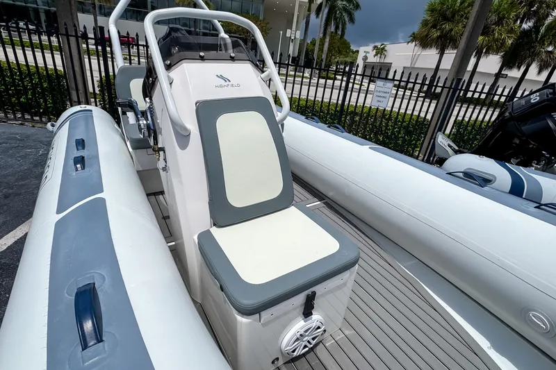 Slide: The Image of 2023 Highfield Classic 420 boat with seating and console, docked outdoors. - 9