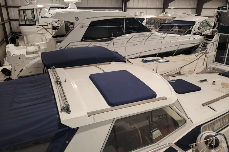 Slide: The Image of Indoor storage of multiple yachts, featuring a 1986 LM 32 model. - 11