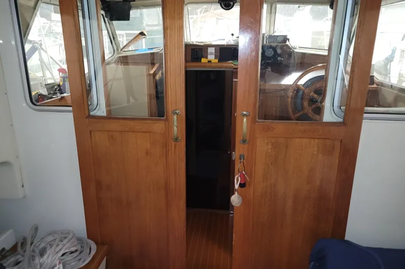 Slide: The Image of Interior view of 1986 LM 32 boat with wooden doors and steering wheel. - 15