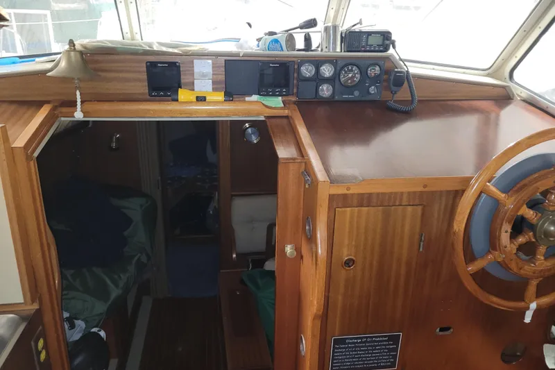 Slide: The Image of Interior of 1986 LM 32 boat with wooden helm and navigation instruments. - 20