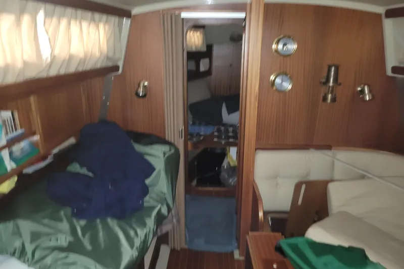 Slide: The Image of Interior of 1986 LM 32 boat with cozy wooden furnishings and nautical decor. - 21