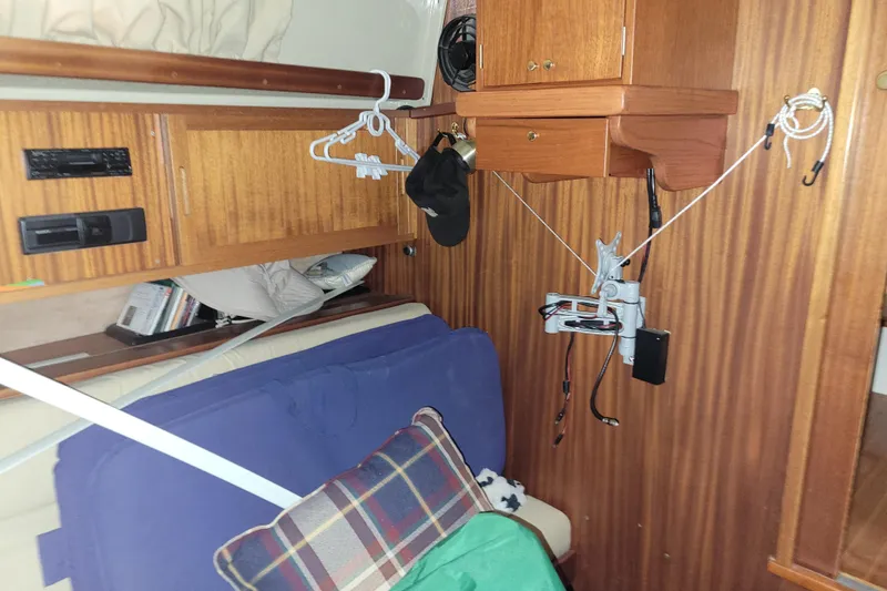 Slide: The Image of Interior of a 1986 LM 32 boat with wooden cabinets and cozy seating area. - 23