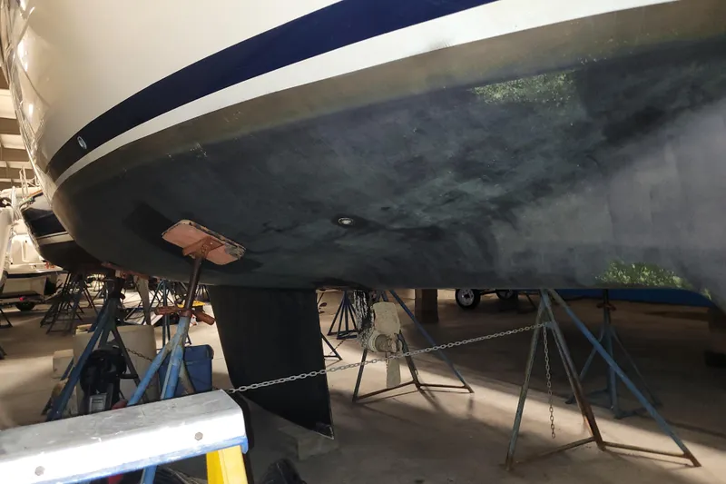 Slide: The Image of 1986 LM 32 boat hull on stands in a maintenance facility. - 36