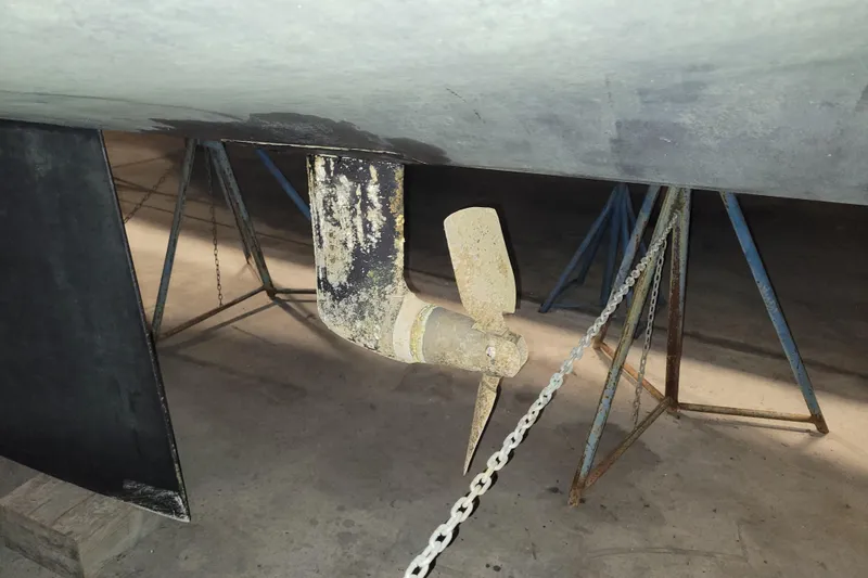 Slide: The Image of Propeller and rudder of 1986 LM 32 boat on stands in a workshop. - 37