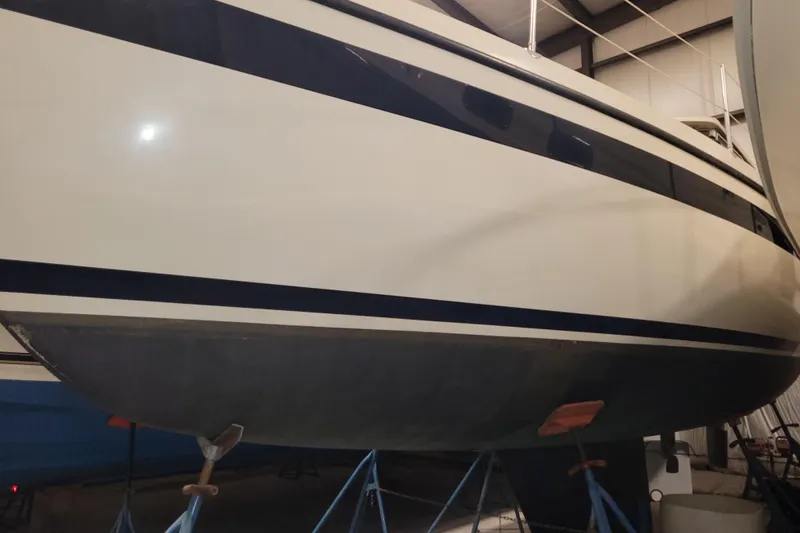 Slide: The Image of 1986 LM 32 sailboat in storage, showcasing sleek hull design and sturdy construction. - 39