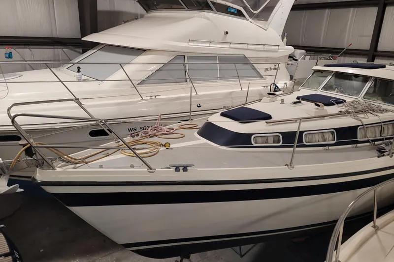 Slide: The Image of 1986 LM 32 boat in storage, featuring sleek design and nautical equipment. - 7