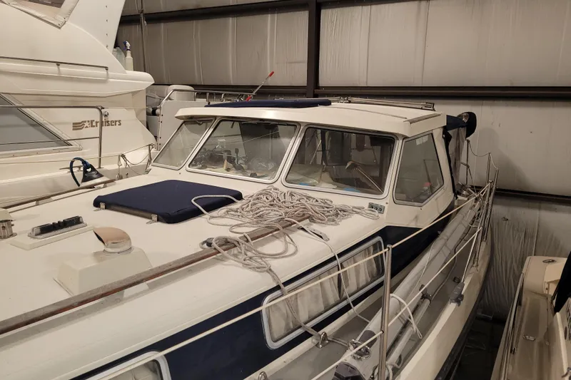 Slide: The Image of 1986 LM 32 boat in storage, featuring a sleek design and nautical equipment. - 9