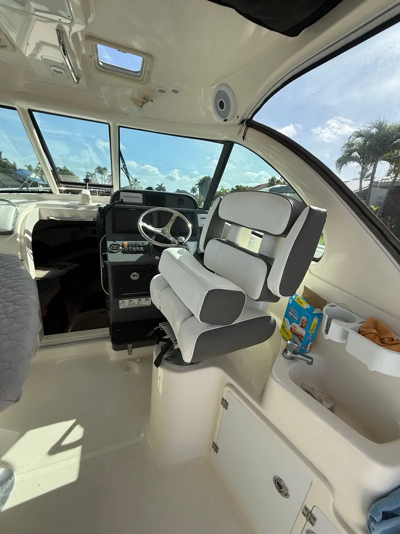 Slide: The Image of Interior of a 2011 Pursuit 315 OS boat with helm station. - 2