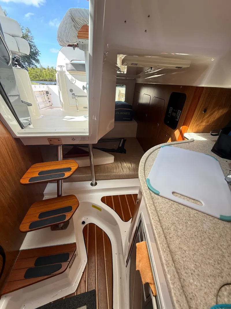 Slide: The Image of Interior of a 2011 Pursuit 315 OS yacht with wooden steps. - 4