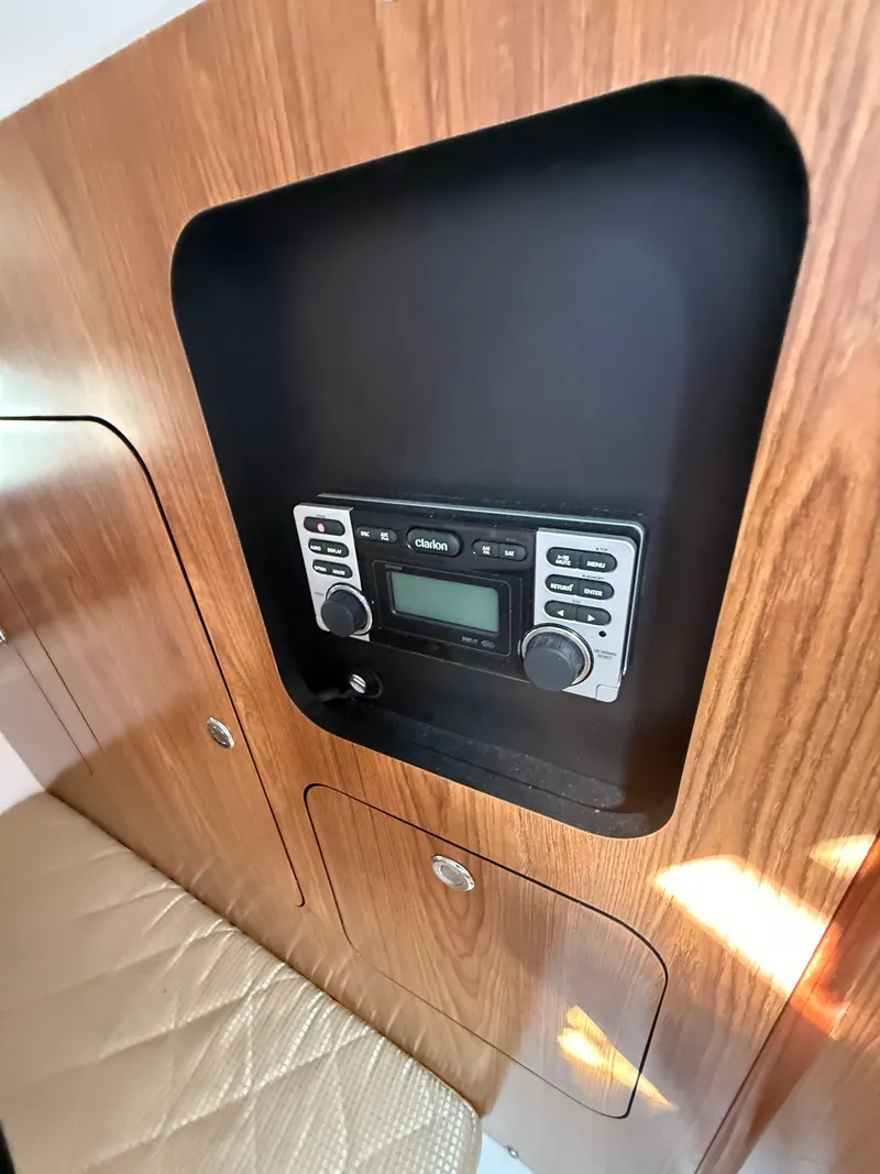 Slide: The Image of Interior of a 2011 Pursuit 315 OS with built-in Clarion radio. - 9