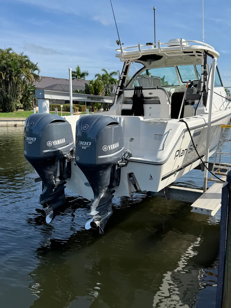 Slide: The Image of 2011 Pursuit 315 OS boat with Yamaha engines in water. - 7
