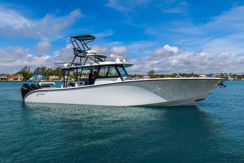 Slide: The Image of 2019 Yellowfin 42 Offshore boat cruising on clear blue water under a partly cloudy sky. - 10