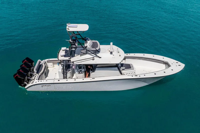 Slide: The Image of 2019 Yellowfin 42 Offshore boat on clear blue water, featuring multiple outboard engines. - 11