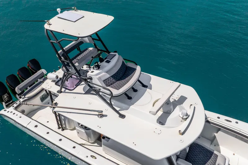 Slide: The Image of 2019 Yellowfin 42 Offshore boat with tower, on clear blue water. - 13
