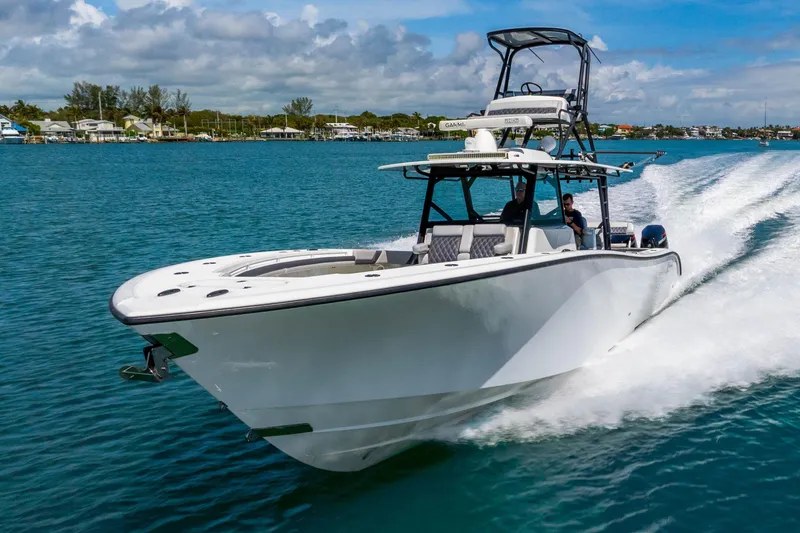 Slide: The Image of 2019 Yellowfin 42 Offshore boat cruising on clear blue water under a sunny sky. - 14