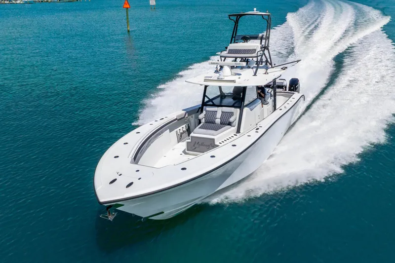 Slide: The Image of 2019 Yellowfin 42 Offshore boat cruising on clear blue water. - 15