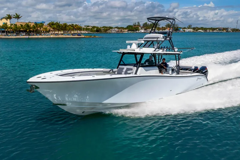 Slide: The Image of 2019 Yellowfin 42 Offshore boat cruising on clear blue water under a partly cloudy sky. - 16