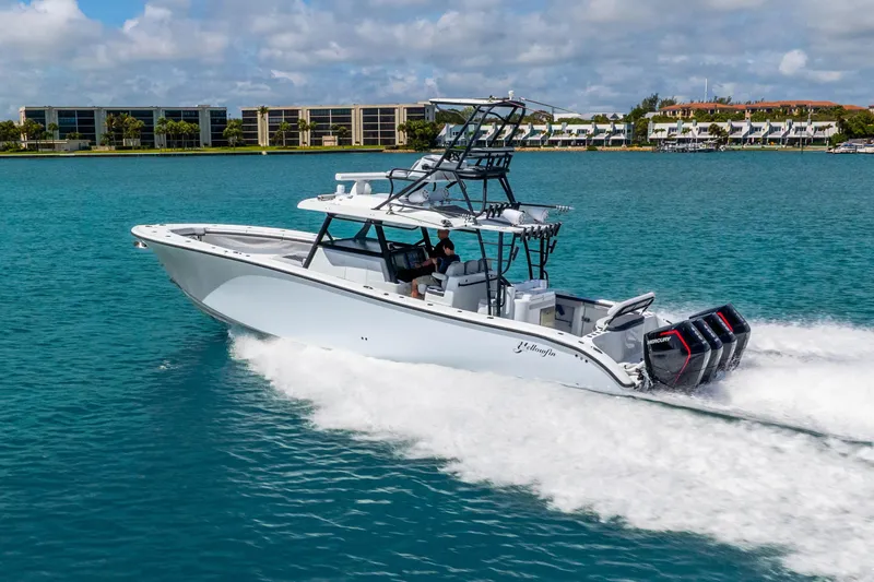 Slide: The Image of 2019 Yellowfin 42 Offshore boat cruising on blue water, showcasing powerful engines. - 17