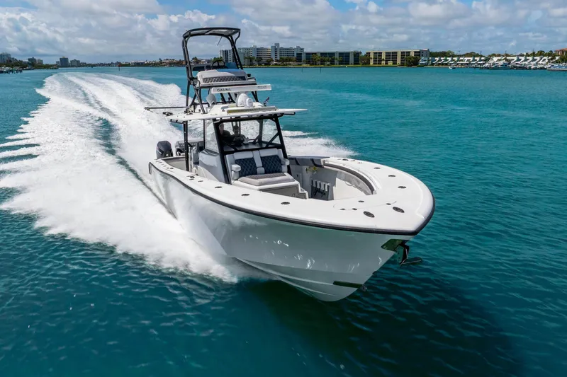 Slide: The Image of 2019 Yellowfin 42 Offshore boat cruising on clear blue water under a sunny sky. - 18