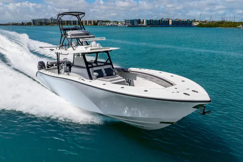Slide: The Image of 2019 Yellowfin 42 Offshore boat cruising on clear blue water. - 19