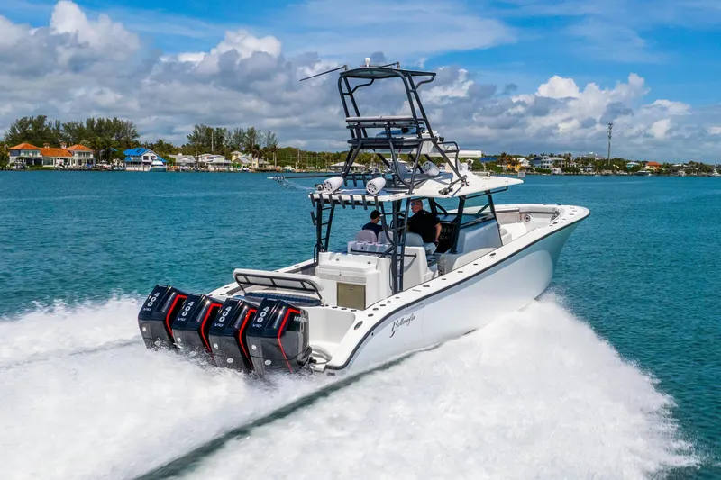 Slide: The Image of 2019 Yellowfin 42 Offshore boat cruising on blue water with powerful engines. - 20