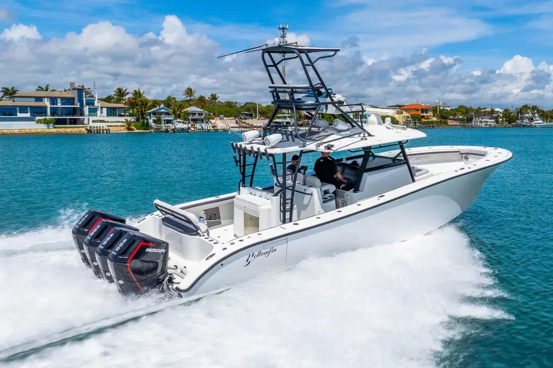 Slide: The Image of 2019 Yellowfin 42 Offshore boat cruising on clear blue water, showcasing powerful engines. - 22
