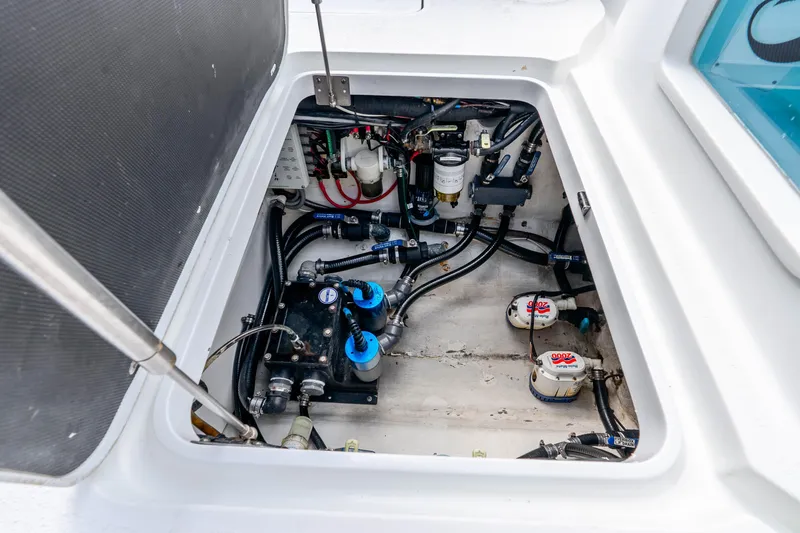 Slide: The Image of Engine compartment of a 2019 Yellowfin 42 Offshore boat, showcasing mechanical components and wiring. - 23