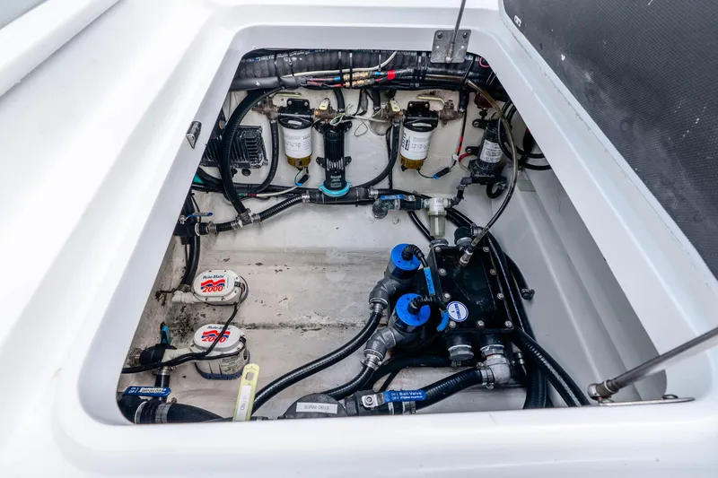 Slide: The Image of Engine compartment of 2019 Yellowfin 42 Offshore boat, showcasing pumps and wiring. - 24