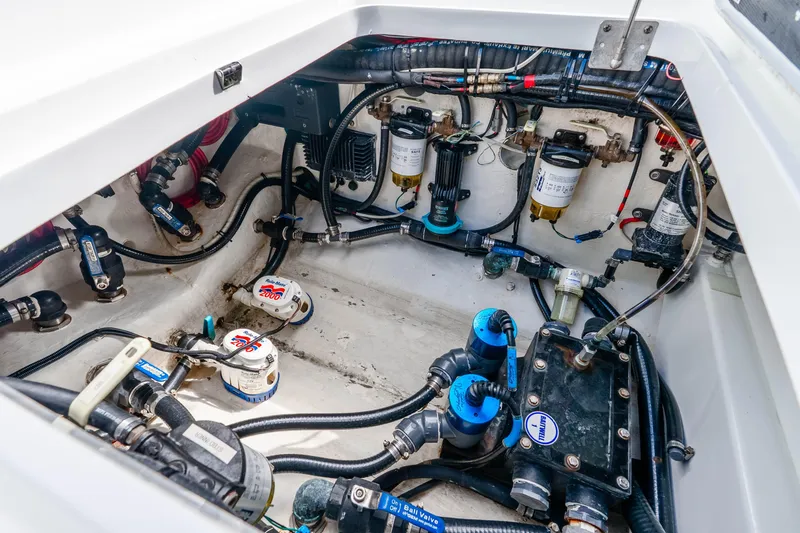 Slide: The Image of Engine compartment of a 2019 Yellowfin 42 Offshore boat, showcasing intricate wiring and components. - 25