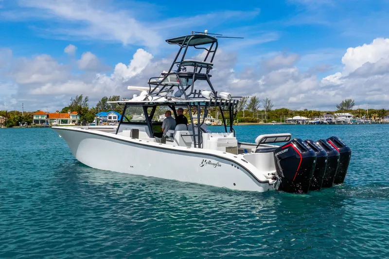 Slide: The Image of 2019 Yellowfin 42 Offshore boat with multiple outboard engines on clear blue water. - 3
