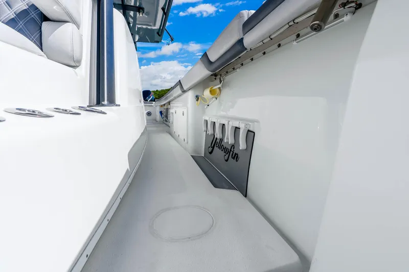 Slide: The Image of 2019 Yellowfin 42 Offshore boat deck with sleek design and rod holders under a blue sky. - 31