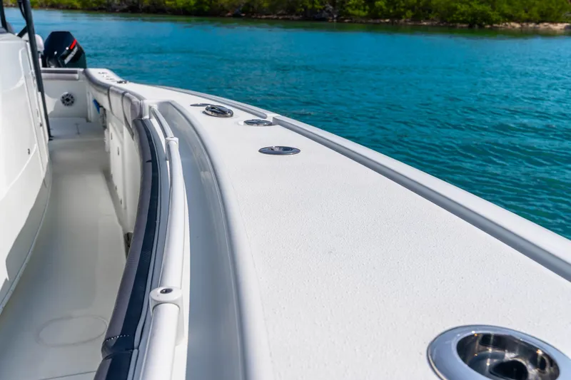 Slide: The Image of 2019 Yellowfin 42 Offshore boat on clear blue water, showcasing sleek design and spacious deck. - 33