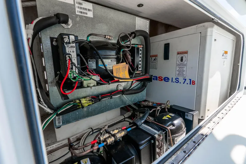 Slide: The Image of Electrical components inside a 2019 Yellowfin 42 Offshore boat compartment. - 36