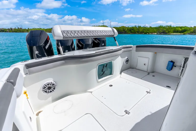 Slide: The Image of 2019 Yellowfin 42 Offshore boat deck with Mercury engines, on a sunny day by the water. - 37
