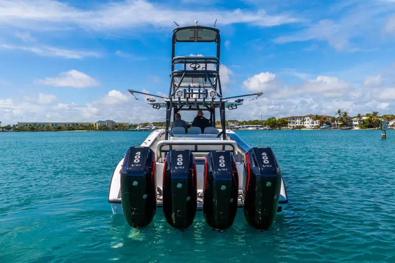Slide: The Image of 2019 Yellowfin 42 Offshore boat with four powerful engines on turquoise water. - 4