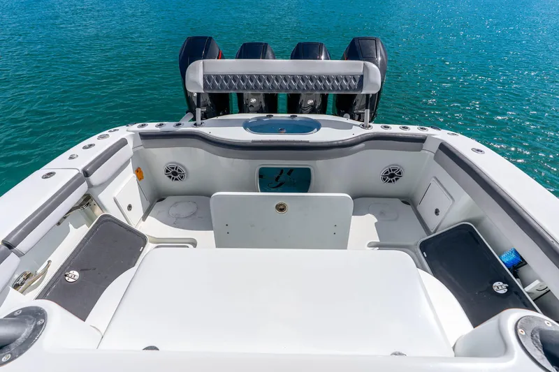 Slide: The Image of 2019 Yellowfin 42 Offshore boat deck with triple outboard engines on blue water. - 41