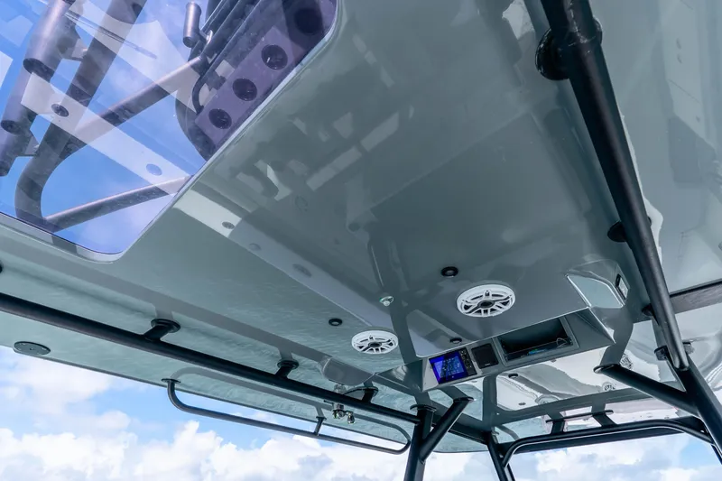 Slide: The Image of 2019 Yellowfin 42 Offshore boat's sleek overhead console with speakers and electronics. - 45